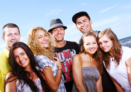 group of young adults on beach smiling